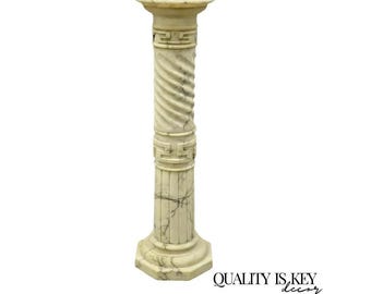May include: A cream-colored, decorative column with a spiral design on the main shaft. The column has a round top and a hexagonal base. The column features a Greek key design near the top and bottom. The words "QUALITY IS KEY decor" are in the bottom right corner.
