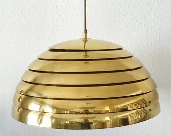 May include: A gold-toned, layered, dome-shaped pendant light fixture.