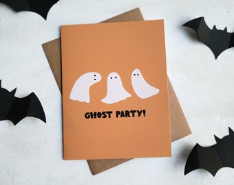 May include: An orange card with three white ghost illustrations and the text "GHOST PARTY!" is displayed on a brown envelope. Black paper bats are scattered around the card, creating a Halloween theme.