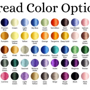 May include: A chart of 50 different thread colors, including white, black, red, blue, green, yellow, orange, purple, pink, brown, and gray. The colors are arranged in a grid pattern and labeled with their names.