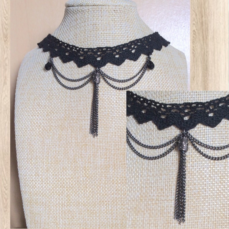 May include: Black lace choker necklace with a dangling chain and a skull charm. The necklace is on a fabric-covered mannequin.