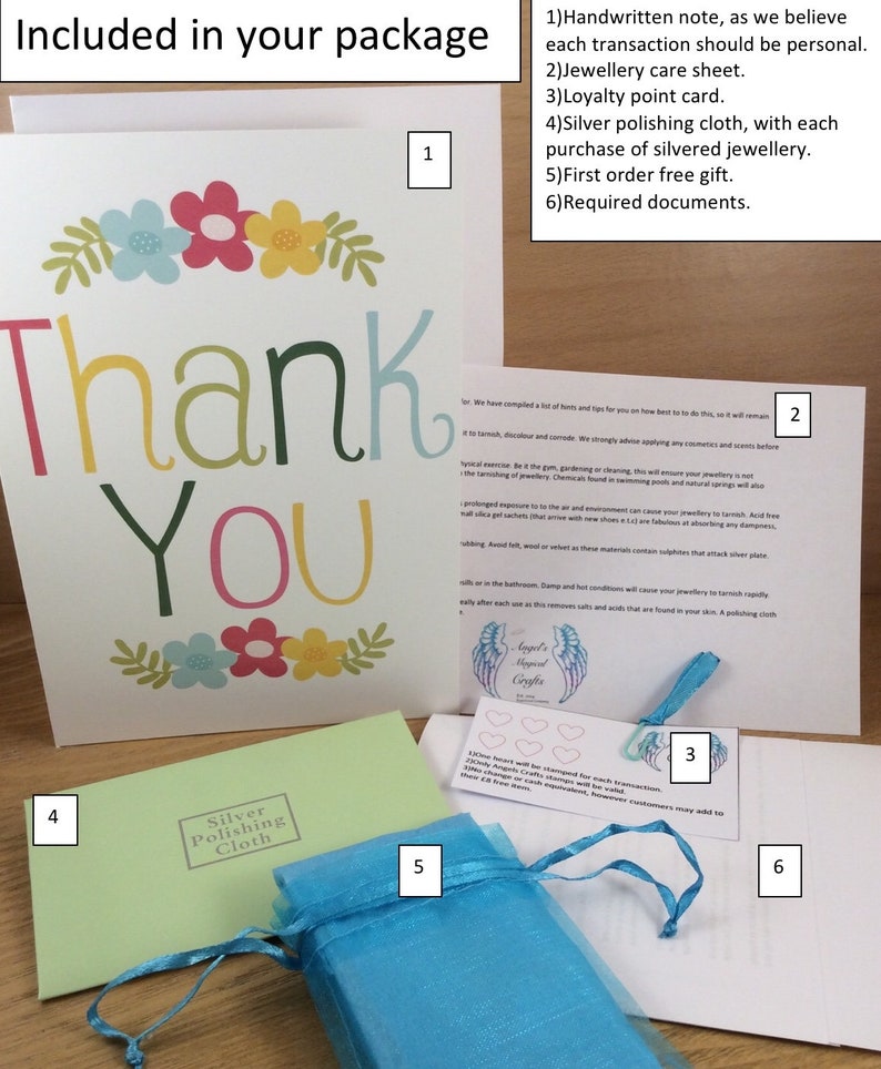 May include: A thank you card with a floral design and the text "Thank You". The card is surrounded by a variety of items included in a package, such as a silver polishing cloth, a handwritten note, a loyalty card, and a small blue bag.