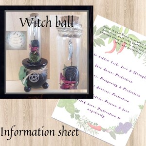 May include: A small glass bottle with a cork top filled with dried herbs and a metal spiral. The bottle is hanging from a small cauldron with a pentagram on the side. The text "Witch ball" is written above the image. The text "Stand in your home throughout the year for protection. Each tube contains a selected blend of herbs believed to bring love and protection." is written on a white card with a floral design.