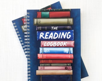 May include: Two blue spiral bound notebooks with a stack of colorful books on the cover. The top notebook says "The Reading Logbook - Log, Rate, and Review 94 Books -"