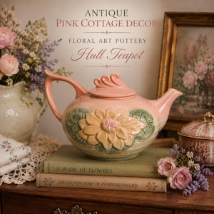 May include: A pink ceramic teapot with a floral design, featuring a large yellow flower with green leaves. The teapot is labeled "Hull Teapot" and sits on a stack of books. The image also includes text that reads "Antique Pink Cottage Decor".
