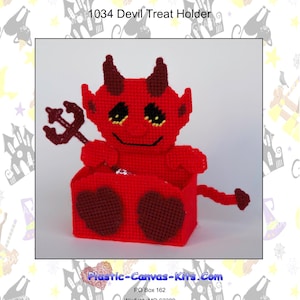 May include: Red felt devil treat holder with a red felt pitchfork and a smiling face. The holder is shaped like a devil with a red felt tail. The text "Plastic-Canvas-Kits.Com" is printed on the bottom of the image.