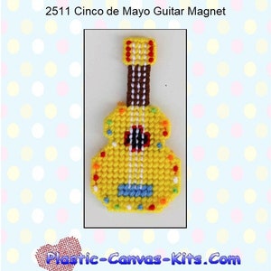 May include: A yellow plastic canvas guitar magnet with a brown neck and colorful details. The magnet is decorated with a Cinco de Mayo theme. The text "Plastic-Canvas-Kits.Com" is visible in the image.