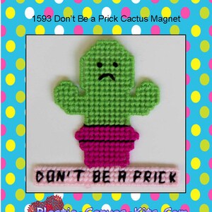 May include: A green cactus with a pink pot and a white banner that says "DON'T BE A PRICK". The cactus has a sad face. This is a plastic canvas kit for a magnet.