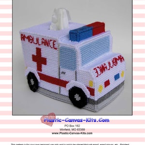 May include: A white plastic canvas tissue box cover with a red cross, blue and red lights, and the word "AMBULANCE" on the side. The cover is designed to look like an ambulance.