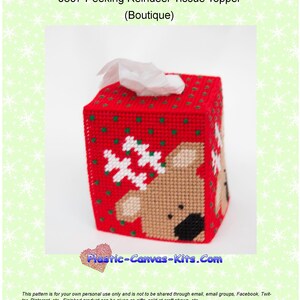 May include: Red and white plastic canvas tissue box cover with a reindeer peeking out. The reindeer is brown with a black nose and antlers. The cover is decorated with snowflakes and green dots. The text "Plastic-Canvas-Kits.Com" is printed on the bottom of the cover.