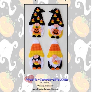 May include: Four plastic canvas gnome magnets with candy corn hats and candy corn accents. The gnomes are wearing black hats and have white faces. The gnomes are holding a pumpkin and a candy corn. The magnets are on a white background with a Halloween pattern.