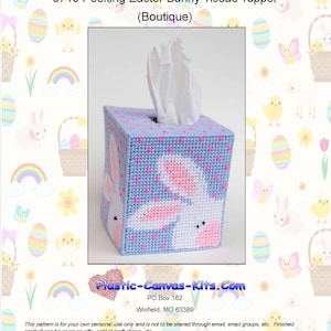 May include: A blue tissue box cover with a pink and white Easter bunny design. The box is square and has a top opening for tissue dispensing. The text "0719 Peeking Easter Bunny Tissue Topper" is visible.
