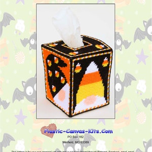 May include: A plastic canvas kit to make a tissue box cover featuring a candy corn gnome peeking out of the box. The box is decorated with candy corn and black and orange stripes. The kit is titled "2750 Peeking Candy Corn Gnomes Tissue Topper".