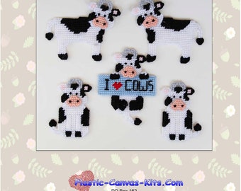 May include: A set of five plastic canvas cow magnets. The magnets feature black and white cows with pink noses and black eyes. One cow is holding a sign that says "I ♥ COWS".