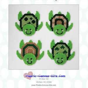 May include: Four plastic canvas kits for making sea turtle magnets. Each kit features a green turtle with a brown shell and a happy face. The kits are labeled "1238 Sea Turtle Magnets".
