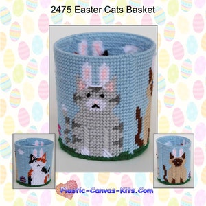 May include: A plastic canvas kit featuring a blue Easter basket with three cats wearing bunny ears. The cats are a gray tabby, a calico, and a Siamese. The kit is titled "2475 Easter Cats Basket".