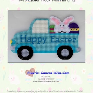 May include: A light blue plastic canvas Easter truck wall hanging with the words "Happy Easter". The truck bed holds a white bunny with pink ears and a purple and yellow Easter egg. Black wheels complete the design.
