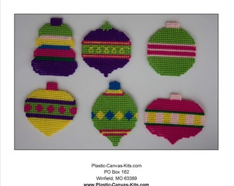 May include: Six colorful plastic canvas Christmas ornament patterns. The ornaments are in the shapes of a heart, a teardrop, and a round ball. The ornaments are decorated with stripes, polka dots, and geometric patterns.