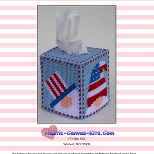 May include: A blue and red plastic canvas tissue box cover with a patriotic gnome design. The gnome is wearing a red, white, and blue hat and has a white beard. The tissue box cover is decorated with stars and stripes.