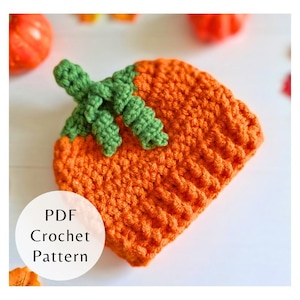 May include: An orange crochet hat with a green stem, resembling a pumpkin. The hat has a ribbed texture and is handmade. The text "PDF Crochet Pattern" is in a white circle on the lower left. Perfect for Halloween or fall.