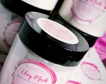 May include: Three glass jars with white labels that say "Clay Mask Sooting Lavender" with pink and purple watercolour designs. The jars are 4 oz each.