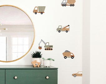 May include: A green dresser with six drawers and gold knobs. The dresser is decorated with brown and gray construction vehicle wall decals. The decals include a dump truck, a cement mixer, a crane, a tow truck, and a car.