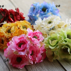 May include: Six bunches of artificial flowers in different colors.  The flowers are arranged in a row on a wooden surface.  The flowers are numbered 1 through 6.  The flowers are all the same type, but they are different colors.  The colors are red, yellow, pink, blue, white, and green.