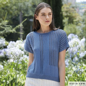 May include: A light blue knitted top with a delicate openwork pattern. The top has short sleeves and a round neckline.