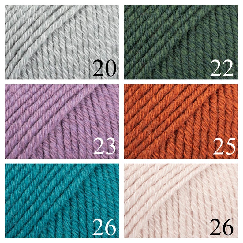 K&ouml;nnte beinhalten: Eine Sammlung von Garnkn&auml;uel in verschiedenen Farben, darunter Grau, Gr&uuml;n, Lila, Orange, T&uuml;rkis und Rosa. Die Kn&auml;uel sind mit den Nummern 20, 22, 23, 25, 26 und 26 gekennzeichnet.