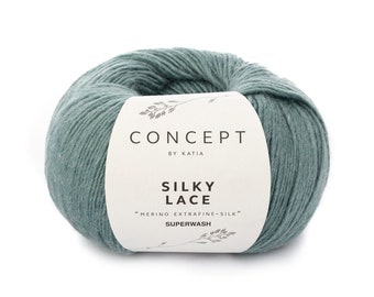 May include: A ball of teal blue yarn labeled "Concept by Katia Silky Lace "Merino Extra Fine-Silk" Superwash"