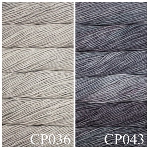 May include: Two skeins of yarn, one in a light grey colour and the other in a dark grey colour. The skeins are labelled CP036 and CP043.