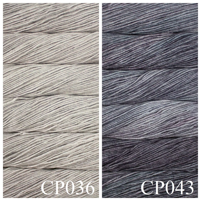 May include: Two skeins of yarn, one in a light grey colour and the other in a dark grey colour. The skeins are labelled CP036 and CP043.