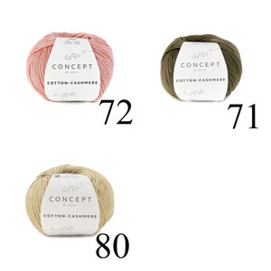 May include: Three balls of yarn in different colors: pink, green, and beige. Each ball has a label that reads "CONCEPT by KATIA COTTON-CASHMERE". The balls are numbered 72, 71, and 80.