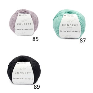 May include: Three balls of yarn in different colors: light purple, light green, and black. Each ball has a label that reads "CONCEPT by KATIA COTTON-CASHMERE". The numbers 85, 87, and 89 are printed below each ball.