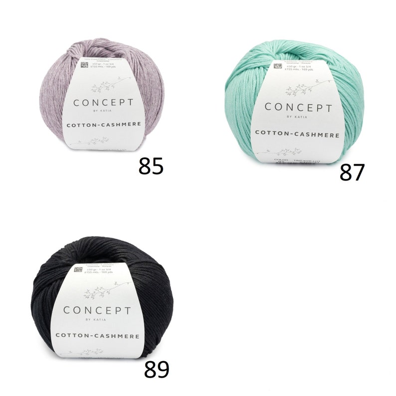 May include: Three balls of yarn in different colors: light purple, light green, and black. Each ball has a label that reads "CONCEPT by KATIA COTTON-CASHMERE". The numbers 85, 87, and 89 are printed below each ball.