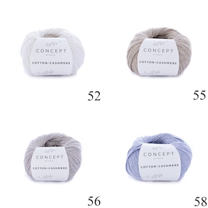 May include: Four skeins of yarn in different colors: white, beige, gray, and light blue. Each skein has a label that reads "CONCEPT by Katia COTTON-CASHMERE".
