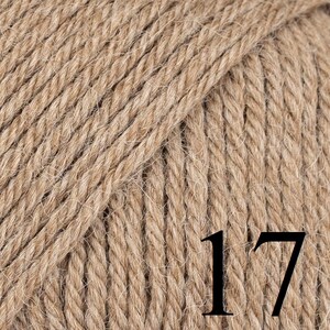 May include: Close-up of a ball of light brown yarn. The yarn is tightly twisted, showing a textured surface. The number "17" is printed in black on the yarn. Ideal for knitting and crochet projects.