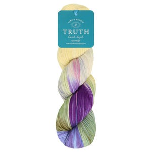 May include: A skein of hand-dyed sock weight yarn in a multi-colored pattern with shades of yellow, green, purple, and blue. The yarn is labeled "Truth hand-dyed Sock Weight" and "Simy's Studio".
