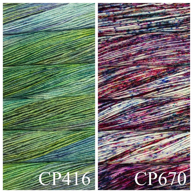 May include: Two skeins of yarn, one green and blue with a variegated pattern and one with a white, pink, and purple variegated pattern. The skeins are labelled CP416 and CP670.