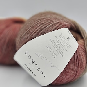 May include: A ball of Concept by Katia Angelo yarn in a pink and brown colorway. The label reads "67% Lana Virgen Laine Vierge Virgin Wool-Schurwolle La Virgem-Scheerwol-Lana Vergine Овечья шерсть первого сотрига Neitsytvilla-Virgin ull-Παρθένο μαλλί 33% Poliamida - Polyamide-Poliamidi - Πολυαμίδη Polyamid - Poliammide - полиамид ±100 gr.-3 oz 1/2 ±450 mts. - 492 yds Concept by Katia Angelo"