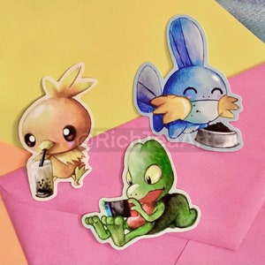 May include: Three cartoon character stickers. One is a brown bird drinking a beverage, another is a blue creature with a food bowl, and the last is a green creature playing a handheld game. The stickers are on a pink and yellow background.