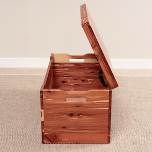 side of open cedar wood blanket chest