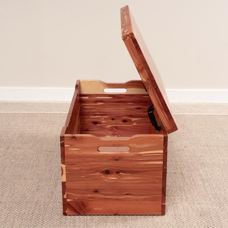 side of open cedar wood blanket chest