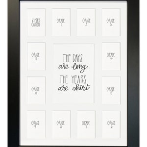 May include: Black picture frame with 12 white photo openings for each grade of school from kindergarten to 12th grade. The text "The days are long, the years are short" is written in the center of the frame.