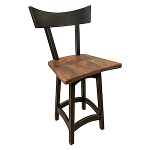 May include: A black wooden bar stool with a curved back and a brown wooden seat. The stool has a simple, rustic design.