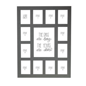 May include: A gray picture frame with 12 openings for photos. Each opening is labeled with a grade level, from Kindergarten to Grade 8. The center opening has the text "The days are long, the years are short".
