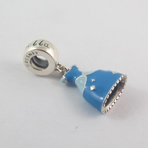 May include: A silver charm featuring a blue enamel dress design. The dress has a light blue bodice and silver stars. The charm has the word "Cinderella" and the Disney logo.