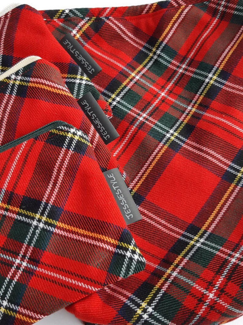 May include: Two red and black plaid fabric pouches with a black label that says "Jessiestyle" on each pouch.