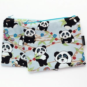 May include: Two blue and white fabric zippered pouches with a panda bear print. The pouches have a turquoise zipper and a small tag that says "JessiesStyle".