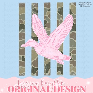 May include: A pink duck illustration in flight, set against a backdrop of vertical camouflage stripes and a light blue sky. The design includes the text "Jessica Knighten ORIGINAL DESIGN."